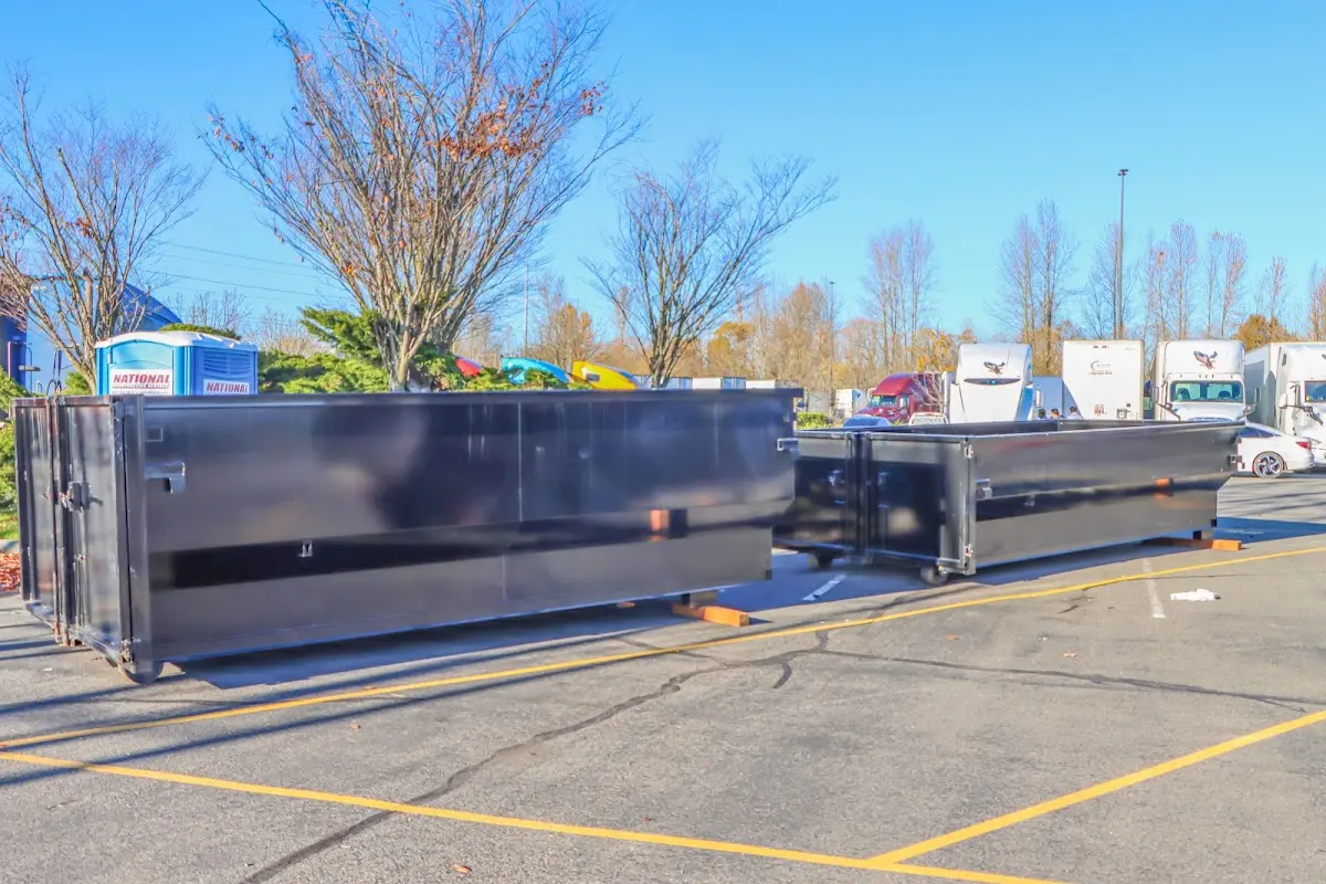 Professional dumpster rental service with roll-off container on residential driveway in Cave Springs